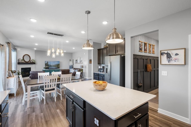 1126 Stonebridge Path, Jordan, MN 55352 - kitchen with stainless steel refrigerator with ice dispenser, open floor plan, a fireplace, dark wood-style floors, and light countertops