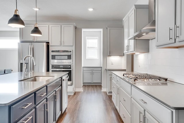 8251 62nd St, Bay South, Cottage Grove, MN 55016 - kitchen featuring wall chimney range hood, stainless steel appliances, gray cabinetry, wood finished floors, and recessed lighting