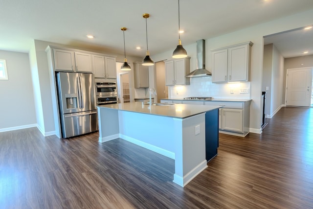 8251 62nd St, Bay South, Cottage Grove, MN 55016 - kitchen with appliances with stainless steel finishes, wall chimney exhaust hood, backsplash, dark wood-style flooring, and a center island with sink