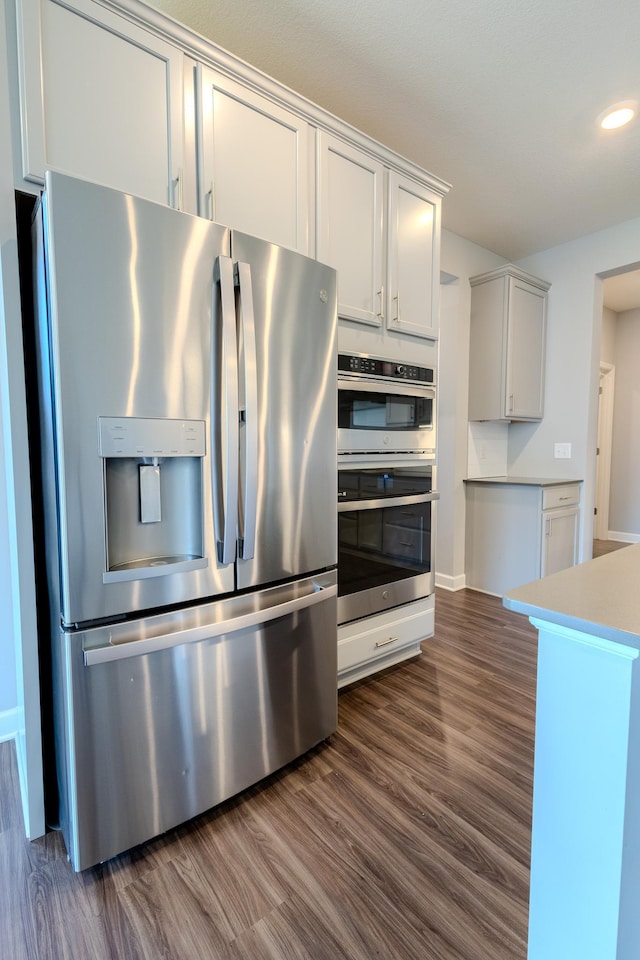 8251 62nd St, Bay South, Cottage Grove, MN 55016 - kitchen featuring stainless steel appliances, dark wood-type flooring, light countertops, and recessed lighting