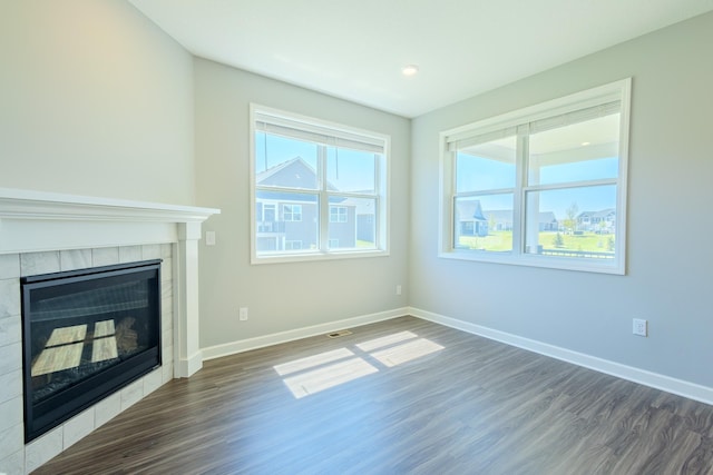 8251 62nd St, Bay South, Cottage Grove, MN 55016 - unfurnished living room featuring wood finished floors and a tile fireplace