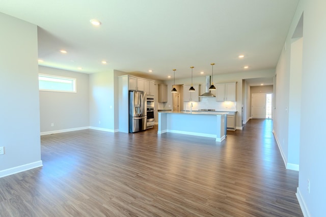 8251 62nd St, Bay South, Cottage Grove, MN 55016 - kitchen featuring appliances with stainless steel finishes, open floor plan, wall chimney range hood, recessed lighting, and a center island with sink