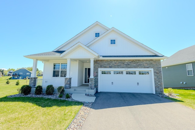 8251 62nd St, Bay South, Cottage Grove, MN 55016 - craftsman inspired home with a garage, concrete driveway, a front yard, a porch, and stone siding