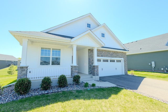 8251 62nd St, Bay South, Cottage Grove, MN 55016 - view of front facade with a porch, driveway, stone siding, and an attached garage