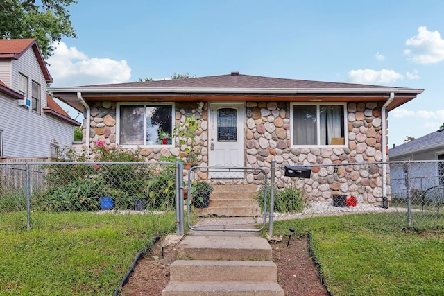 3825 2 1/2 St NE, Columbia Heights, MN 55421 - bungalow featuring stone siding, a fenced front yard, a gate, and roof with shingles