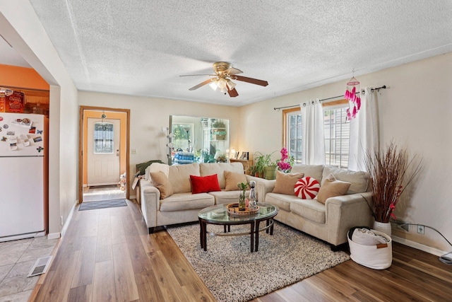 3825 2 1/2 St NE, Columbia Heights, MN 55421 - living area featuring wood finished floors, ceiling fan, and a textured ceiling