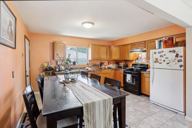 3825 2 1/2 St NE, Columbia Heights, MN 55421 - kitchen featuring freestanding refrigerator, black gas range oven, and under cabinet range hood