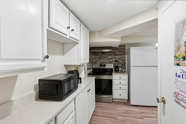 3825 2 1/2 St NE, Columbia Heights, MN 55421 - kitchen with freestanding refrigerator, stainless steel electric stove, black microwave, white cabinets, and ventilation hood