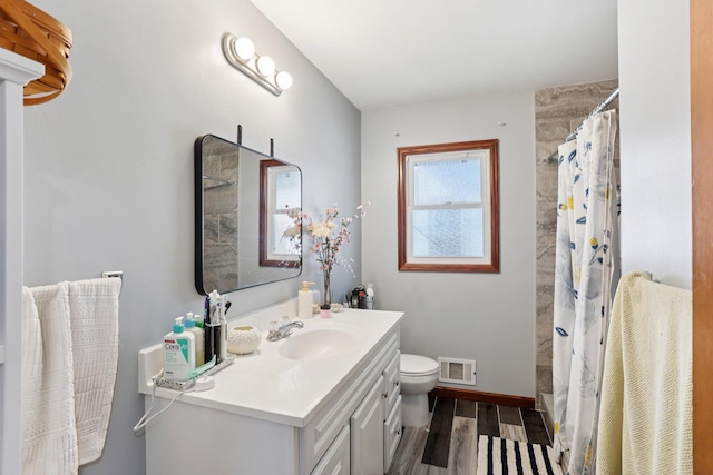 3825 2 1/2 St NE, Columbia Heights, MN 55421 - full bathroom with wood finished floors, vanity, and curtained shower