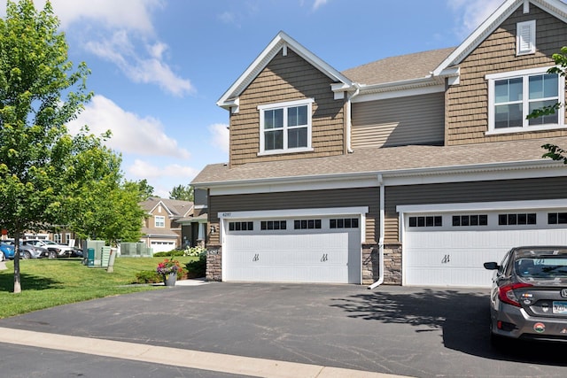 4297 Corn Silk Ln, Woodbury, MN 55129 - view of front of home with roof with shingles, asphalt driveway, an attached garage, and a front lawn
