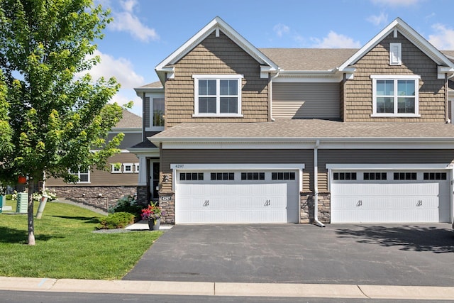4297 Corn Silk Ln, Woodbury, MN 55129 - view of front of home with a garage, asphalt driveway, roof with shingles, and a front lawn