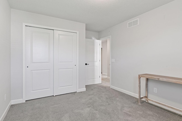 4297 Corn Silk Ln, Woodbury, MN 55129 - unfurnished bedroom featuring carpet, a closet, and a textured ceiling