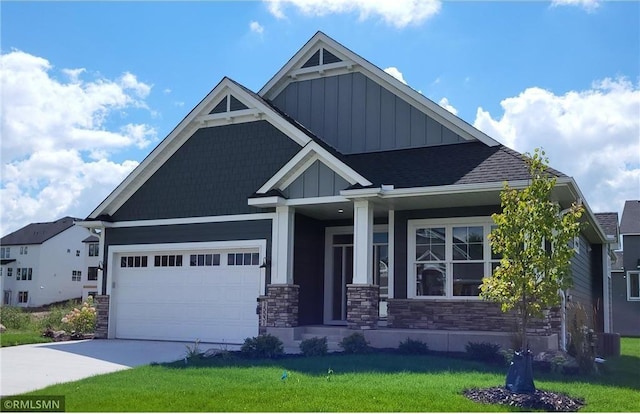15531 111th Ave N, Dayton, MN 55369 - craftsman house featuring board and batten siding, a front yard, stone siding, driveway, and an attached garage