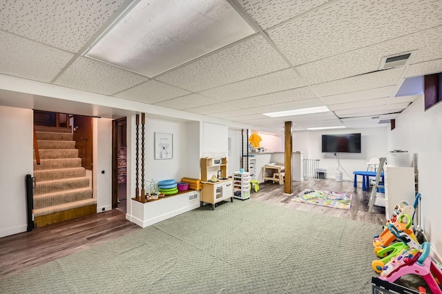 1268 Stanford Ave, Saint Paul, MN 55105 - finished basement with wood finished floors, a paneled ceiling, and stairway