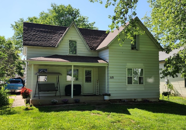 315 Woodworth St, Elmwood, WI 54740 - view of front of house featuring a front yard, covered porch, and roof with shingles