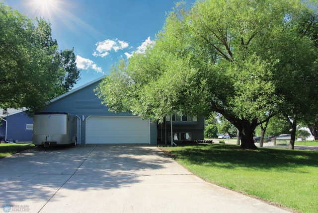 3101 Chelsea Ave S, Moorhead, MN 56560 - obstructed view of property with a garage, a front yard, and concrete driveway