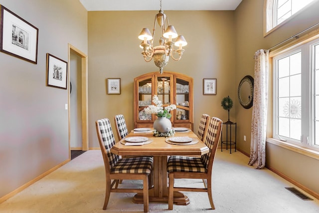 2064 141st Ln NE, Ham Lake, MN 55304 - dining room with a chandelier, light carpet, a high ceiling, and healthy amount of natural light