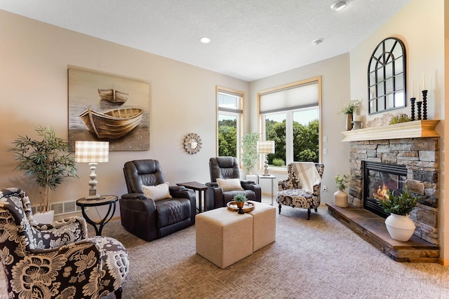 2064 141st Ln NE, Ham Lake, MN 55304 - carpeted living room with a fireplace, a textured ceiling, and recessed lighting