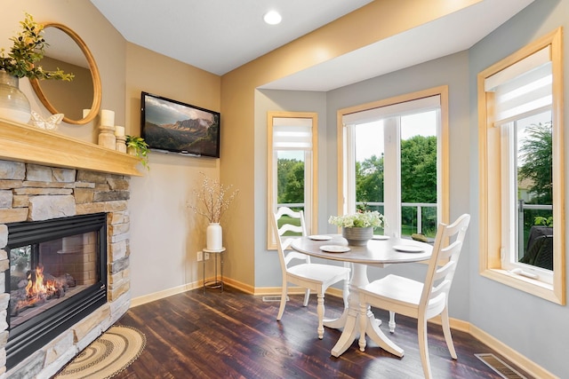 2064 141st Ln NE, Ham Lake, MN 55304 - dining space with dark wood-style floors and a fireplace