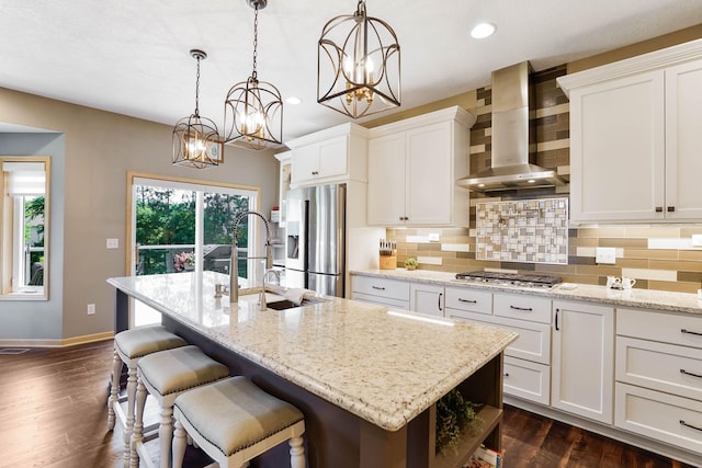 2064 141st Ln NE, Ham Lake, MN 55304 - kitchen with wall chimney exhaust hood, stainless steel appliances, backsplash, white cabinetry, and recessed lighting