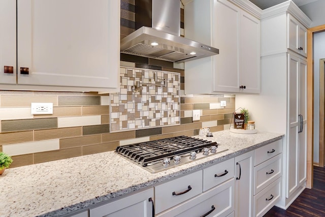 2064 141st Ln NE, Ham Lake, MN 55304 - kitchen featuring island range hood, stainless steel gas cooktop, white cabinetry, tasteful backsplash, and light stone countertops