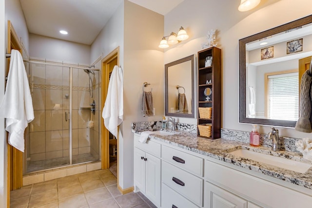 2064 141st Ln NE, Ham Lake, MN 55304 - bathroom with double vanity, a shower stall, tile patterned flooring, and recessed lighting