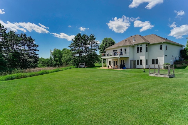 2064 141st Ln NE, Ham Lake, MN 55304 - rear view of property featuring a lawn, a deck, and a patio