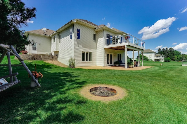 2064 141st Ln NE, Ham Lake, MN 55304 - rear view of house with a lawn, a patio area, an outdoor fire pit, french doors, and a wooden deck