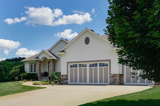 2064 141st Ln NE, Ham Lake, MN 55304 - view of front facade with stone siding, stucco siding, an attached garage, driveway, and a front lawn