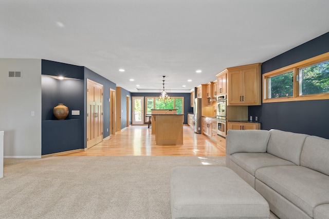 9610 28th Ave N, Plymouth, MN 55441 - living area featuring light carpet, recessed lighting, a chandelier, and light wood-style floors