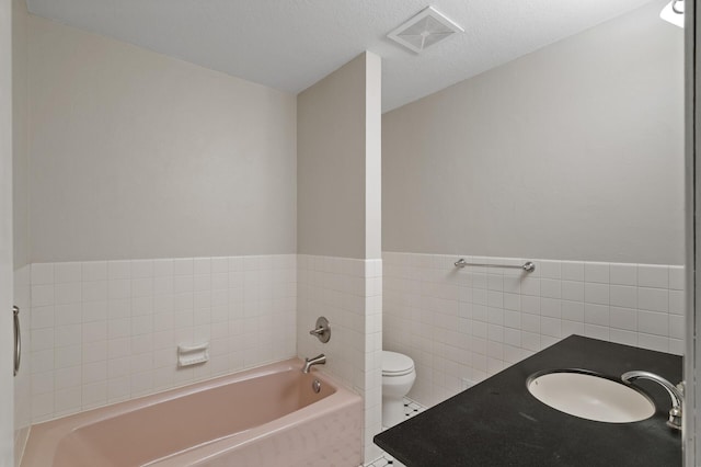 9610 28th Ave N, Plymouth, MN 55441 - bathroom featuring a garden tub, tile walls, and vanity