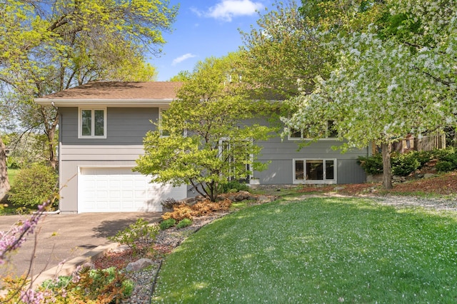 9610 28th Ave N, Plymouth, MN 55441 - view of front of property featuring driveway, an attached garage, and a front lawn
