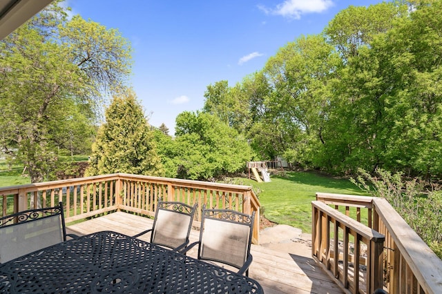 9610 28th Ave N, Plymouth, MN 55441 - deck featuring outdoor dining space, a lawn, a playground, and view of wooded area