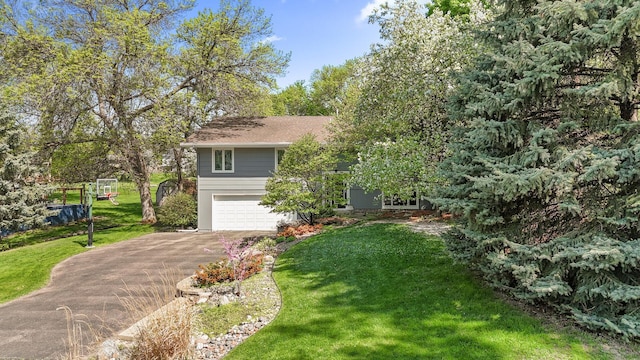 9610 28th Ave N, Plymouth, MN 55441 - view of front of house featuring driveway, a garage, and a front yard