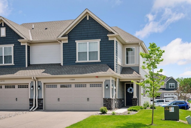 10888 Territorial Trl, Dayton, MN 55369 - multi unit property with an attached garage, driveway, stone siding, a front lawn, and roof with shingles