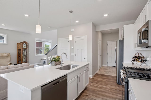 10888 Territorial Trl, Dayton, MN 55369 - kitchen featuring stainless steel appliances, recessed lighting, light wood finished floors, white cabinets, and light countertops
