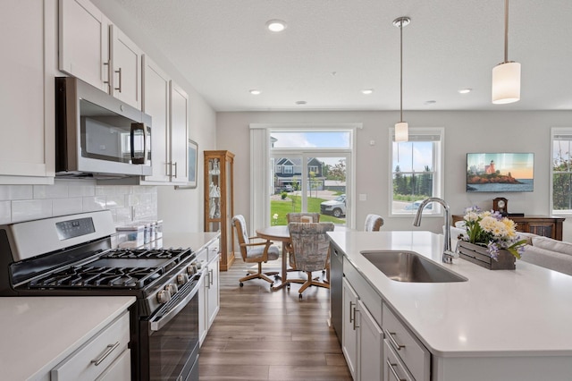 10888 Territorial Trl, Dayton, MN 55369 - kitchen with appliances with stainless steel finishes, dark wood-type flooring, light countertops, hanging light fixtures, and recessed lighting