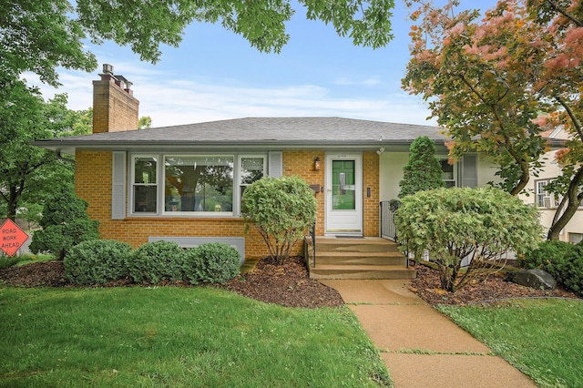 5750 Harriet Ave, Minneapolis, MN 55419 - view of front of house with brick siding, a chimney, a front yard, and roof with shingles