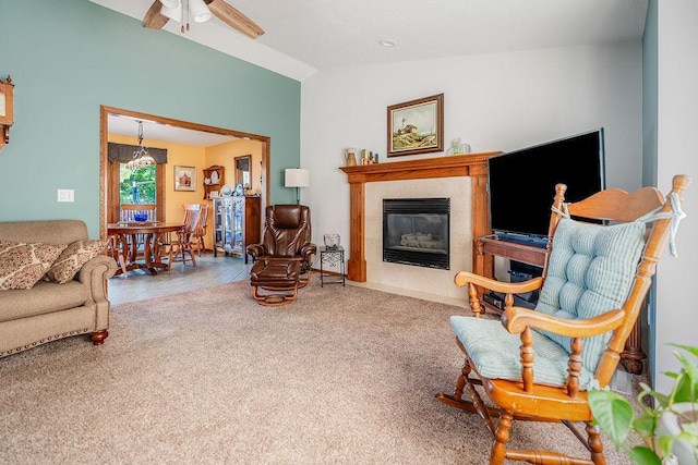 2711 Cedar Ave, Holmen, WI 54636 - living room featuring vaulted ceiling, a ceiling fan, a tile fireplace, carpet floors, and a chandelier