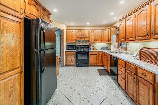 2711 Cedar Ave, Holmen, WI 54636 - kitchen featuring black appliances, decorative backsplash, light tile patterned floors, brown cabinetry, and light countertops