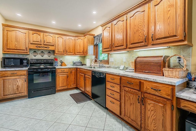 2711 Cedar Ave, Holmen, WI 54636 - kitchen featuring black appliances, brown cabinetry, decorative backsplash, light tile patterned flooring, and recessed lighting