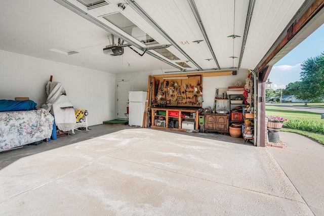 2711 Cedar Ave, Holmen, WI 54636 - garage featuring freestanding refrigerator and a garage door opener