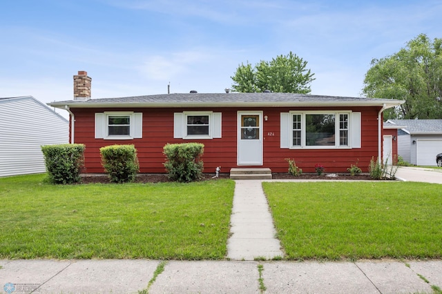 426 3rd Ave E, West Fargo, ND 58078 - view of front of home featuring a chimney, a front yard, and entry steps