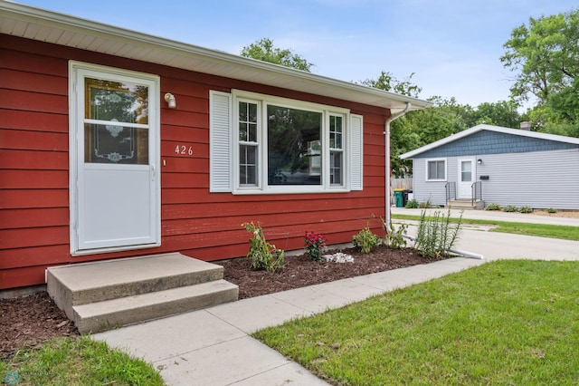 426 3rd Ave E, West Fargo, ND 58078 - view of front of home featuring a front yard and entry steps