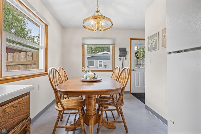 426 3rd Ave E, West Fargo, ND 58078 - dining room featuring a chandelier and tile patterned floors