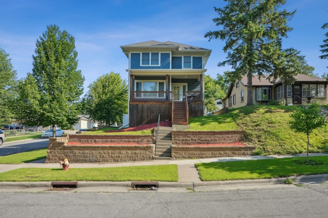 1661 Bush Ave, Saint Paul, MN 55106 - view of front facade featuring stairway, covered porch, and a front lawn