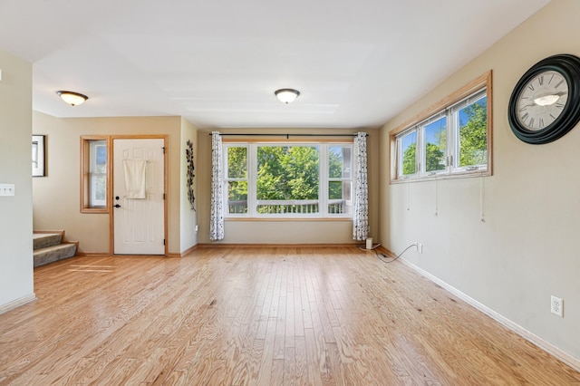 1661 Bush Ave, Saint Paul, MN 55106 - unfurnished living room featuring stairway and wood finished floors