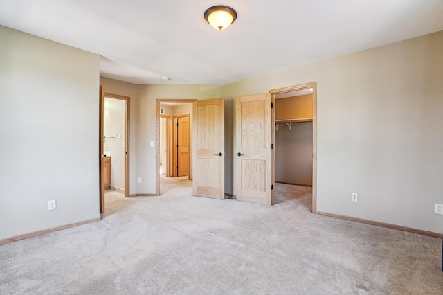 1661 Bush Ave, Saint Paul, MN 55106 - unfurnished bedroom with light carpet, a walk in closet, a closet, and ensuite bathroom