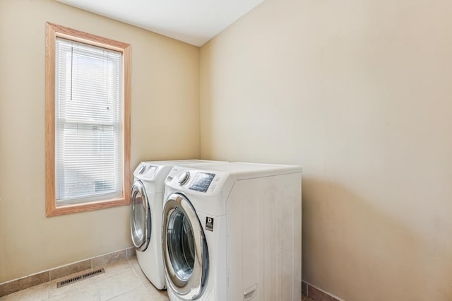 1661 Bush Ave, Saint Paul, MN 55106 - laundry room featuring washer and dryer and light tile patterned flooring
