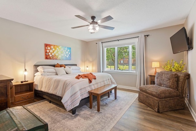 905 Sellards Dr, Dassel, MN 55325 - bedroom with wood finished floors, a ceiling fan, and a textured ceiling
